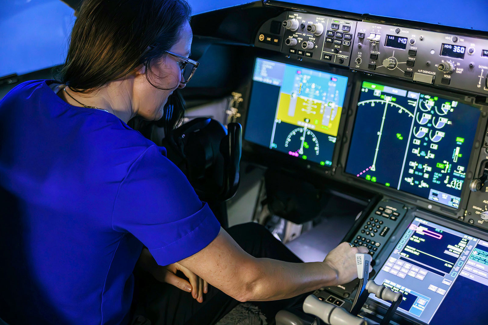 ROLE MODEL: Kelly Zimmermann prepares a flight deck simulator to highlight the crucial role of aircraft simulation in large-scale integration labs.