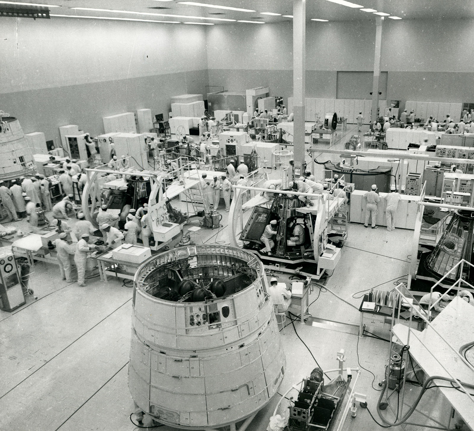 Black and white photo of several people working in lab