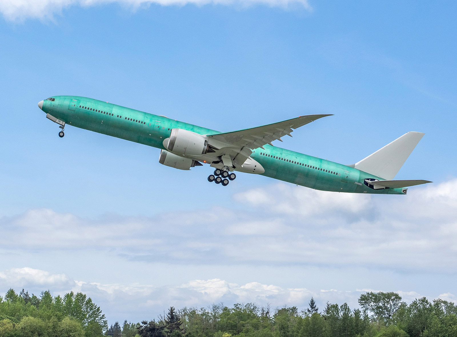 Boeing 777-9 is shown taking off from an airport