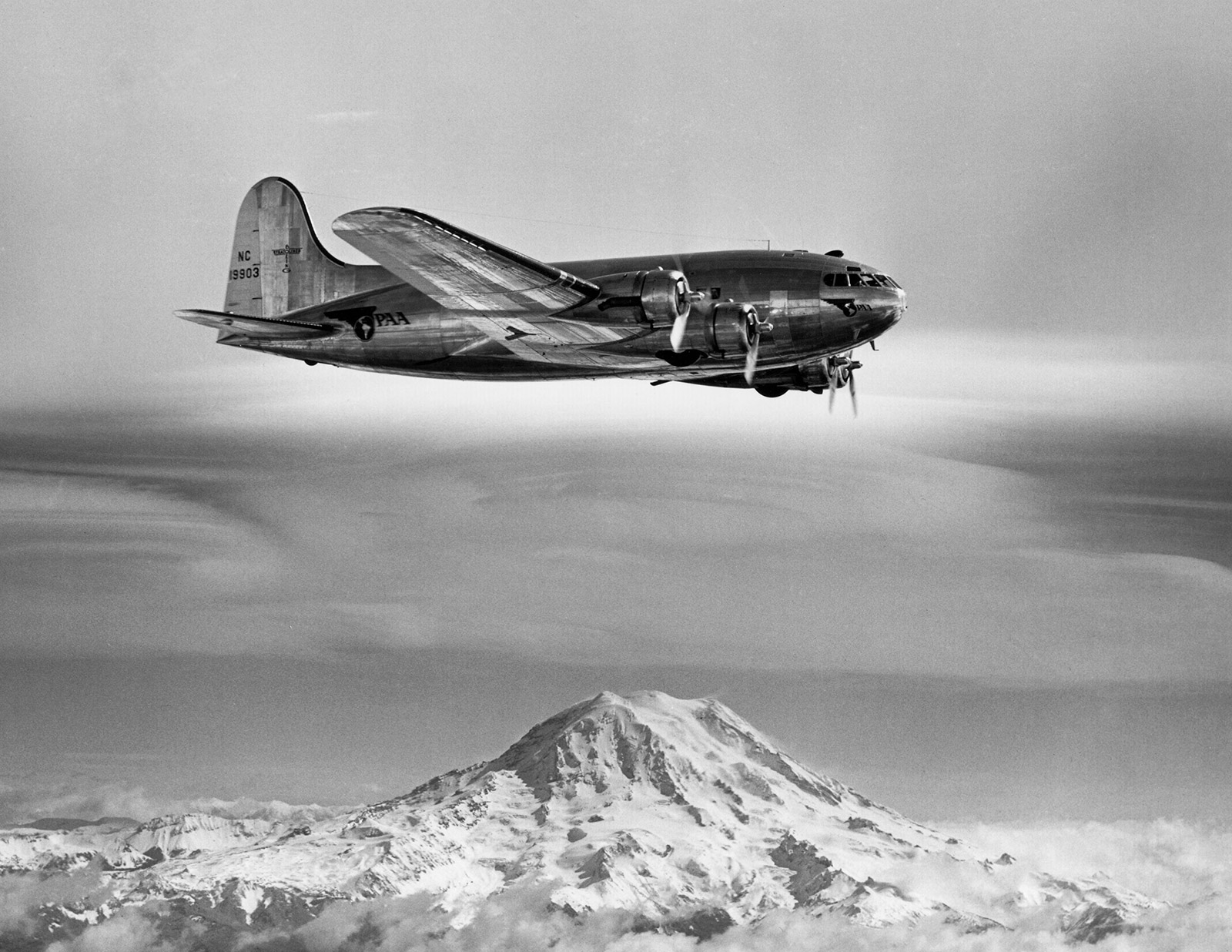 black and white photo of Stratocruiser flying over Mt. Rainier