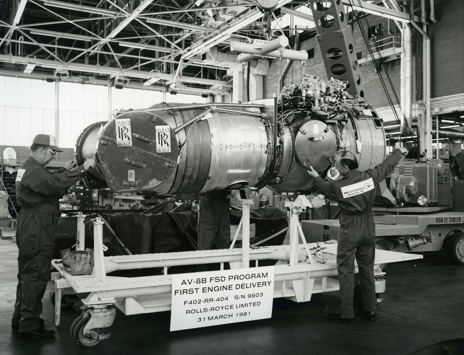 black and white image of people working on engine