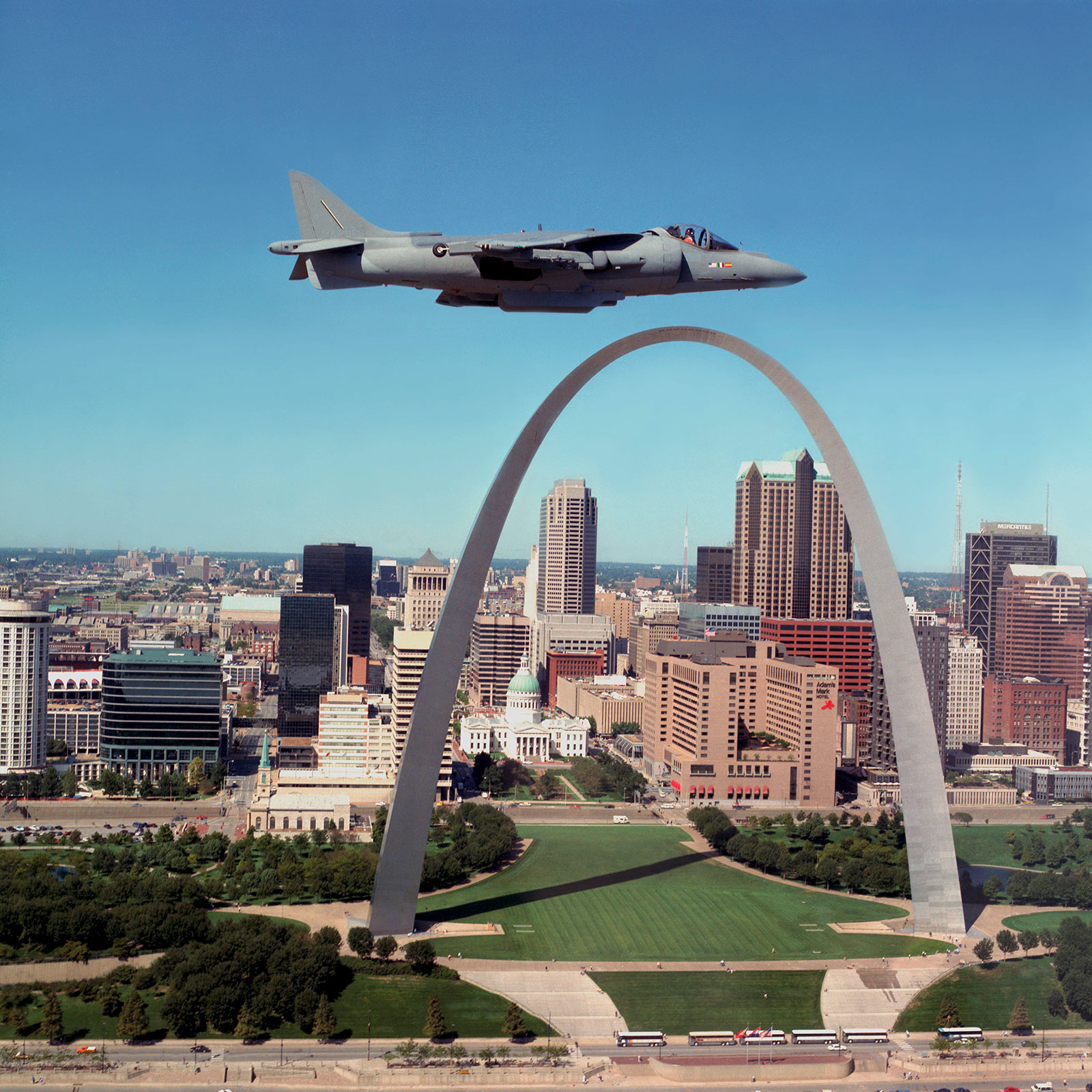 Color photo of Harrier flying over St. Louis arch