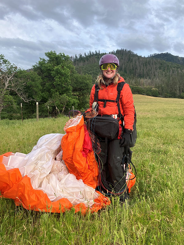 Eileen Kutscha stands with her gear after a flight.