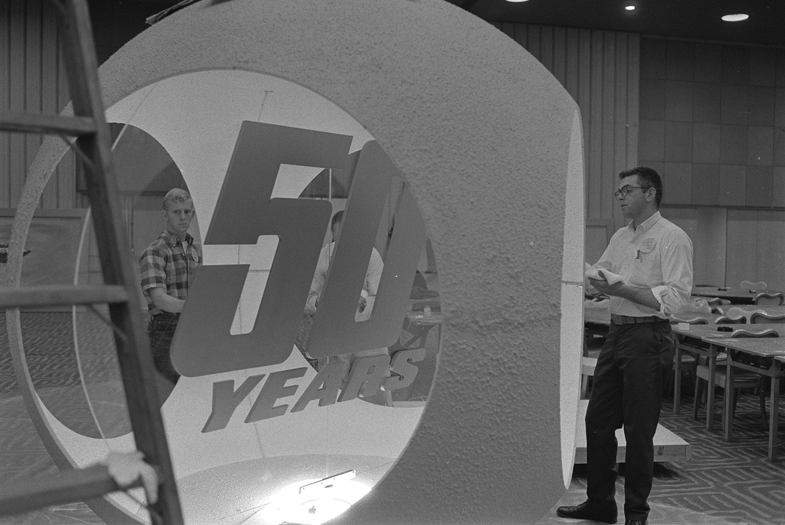 Black and white photo of 50th anniversary sign
