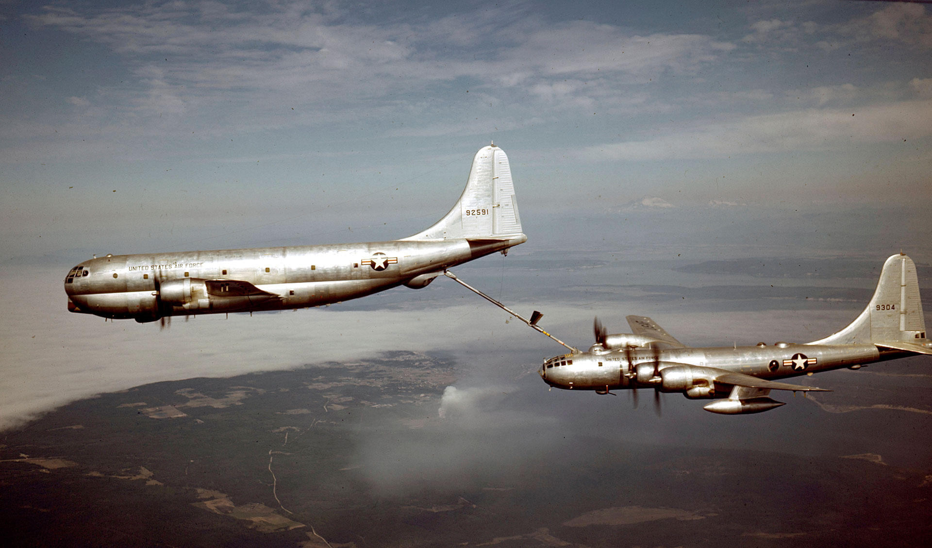 Color photo of KC-97 refueling a B-50 in flight