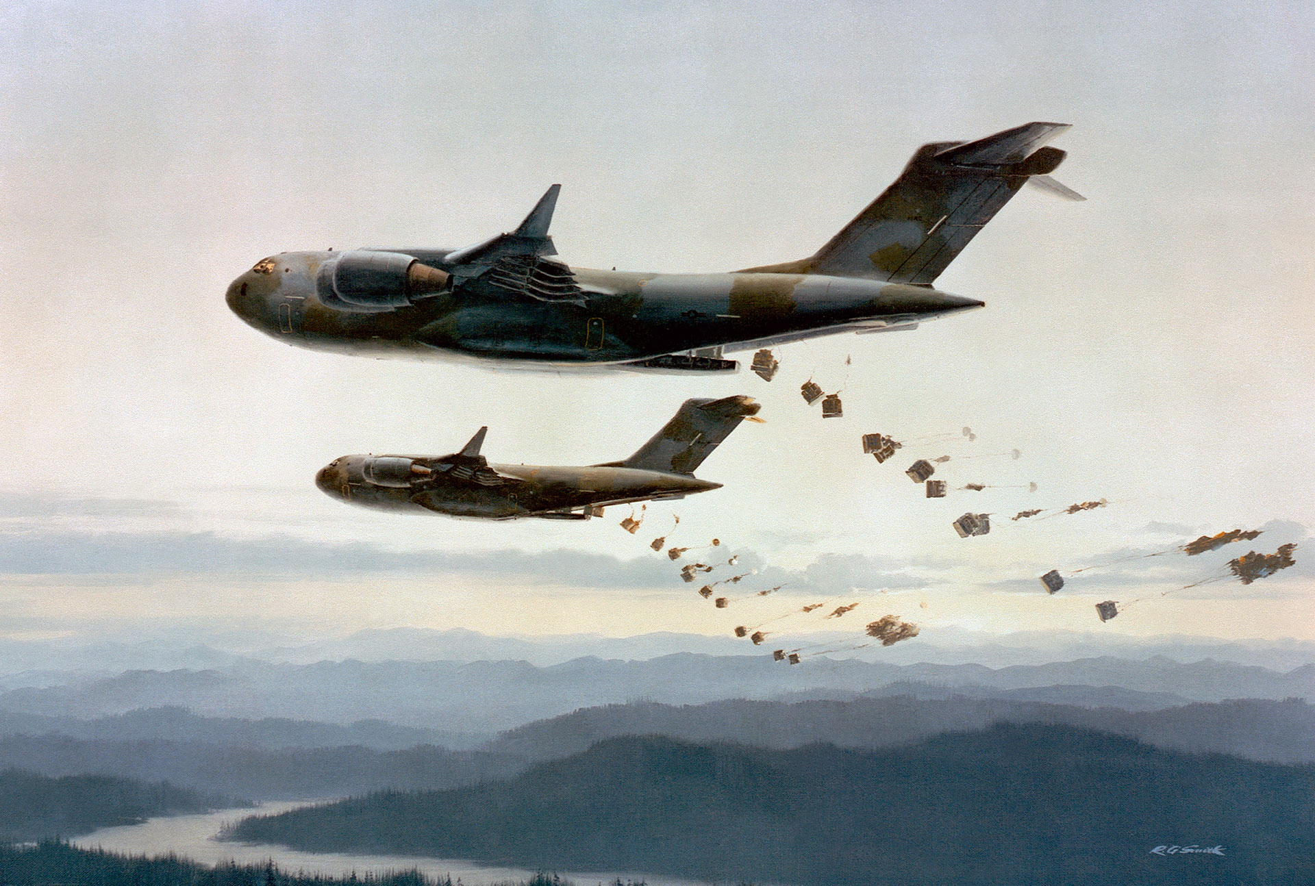 A military cargo aircraft flying over layered mountains releases multiple bundles of supplies or cargo from its rear, with a second aircraft flying below it in the same formation.
