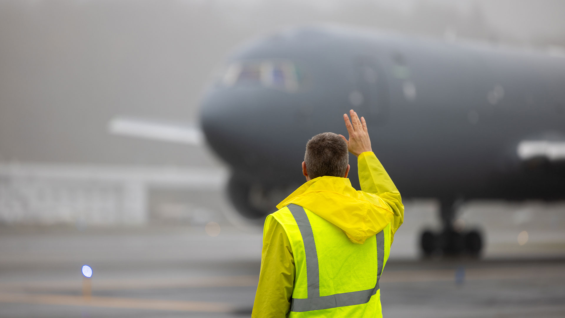 Boeing employee Eric Thorley waves as the KC-46 delivered to his son’s squadron taxis down the runway for departure.