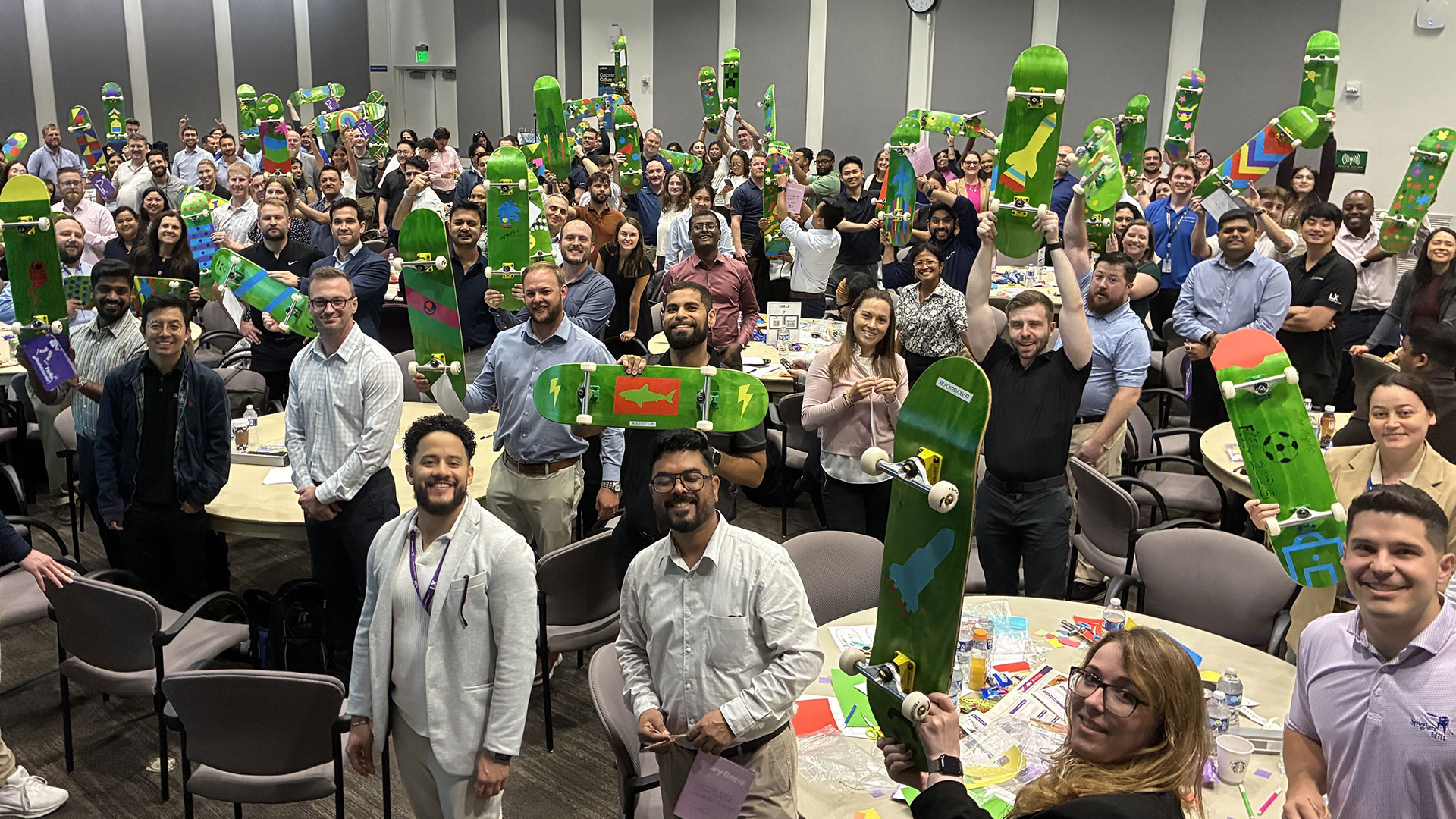 Boeing Leadership Next (LX) teammates show the 57 skateboards they assembled for children of partner non-profits Children Think and the Boys & Girls Clubs of Huntington Valley.