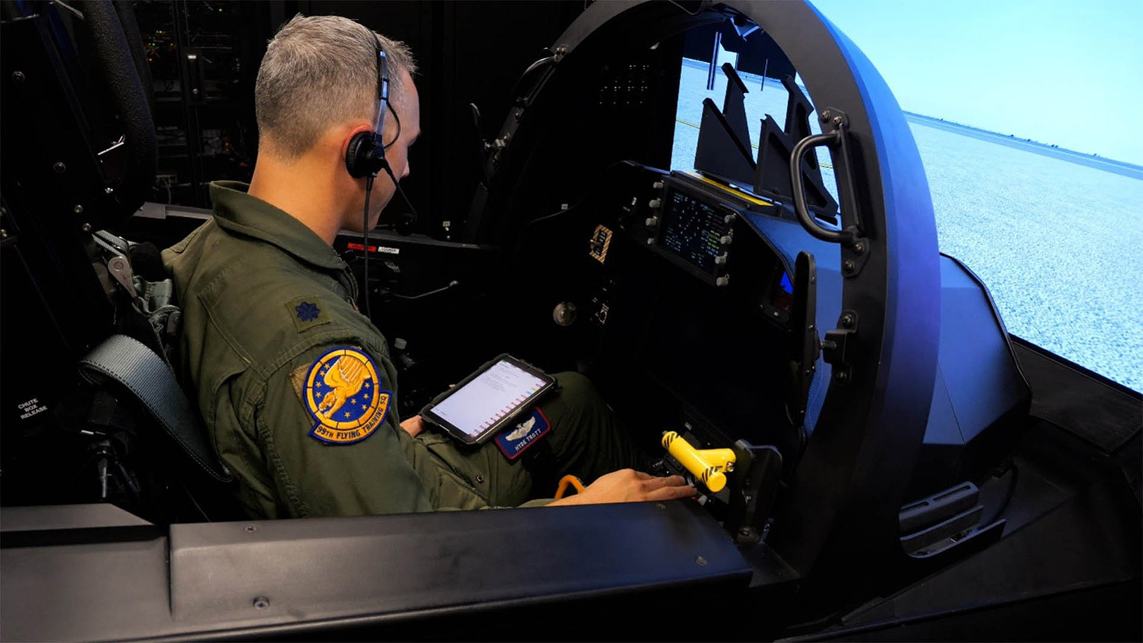 A member of the U.S. Air Force sits inside a T-7A Red Hawk simulator