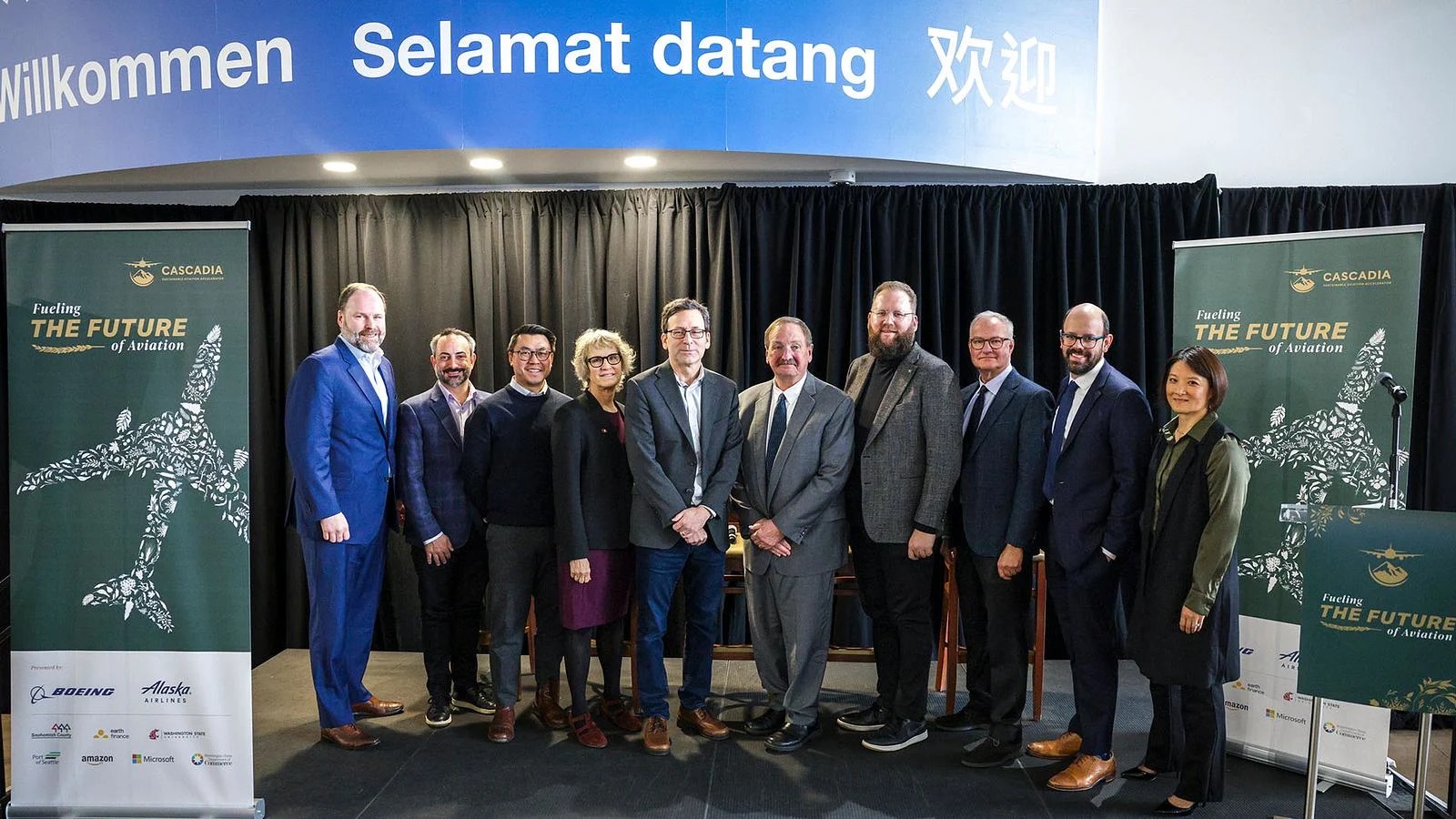 Above, from left: Bill McSherry, Boeing vice president of Government Operations; Guy Palumbo, Amazon director of public policy; Joe Nguyen, Washington State Department of Commerce director; Elizabeth Cantwell, Washington State University president; Washington Gov. Bob Ferguson; Snohomish County Executive Dave Somers; Washington state Sen. Marko Liias; Tim Zenk, Earth Finance managing director; Ryan Spies, Alaska Air Group managing director of sustainability; and Washington state Rep. Mia Gregerson attend a launch event for the Cascadia Sustainable Aviation Accelerator at the Boeing Future of Flight in Mukilteo, Washington, on Jan. 8, 2026. 