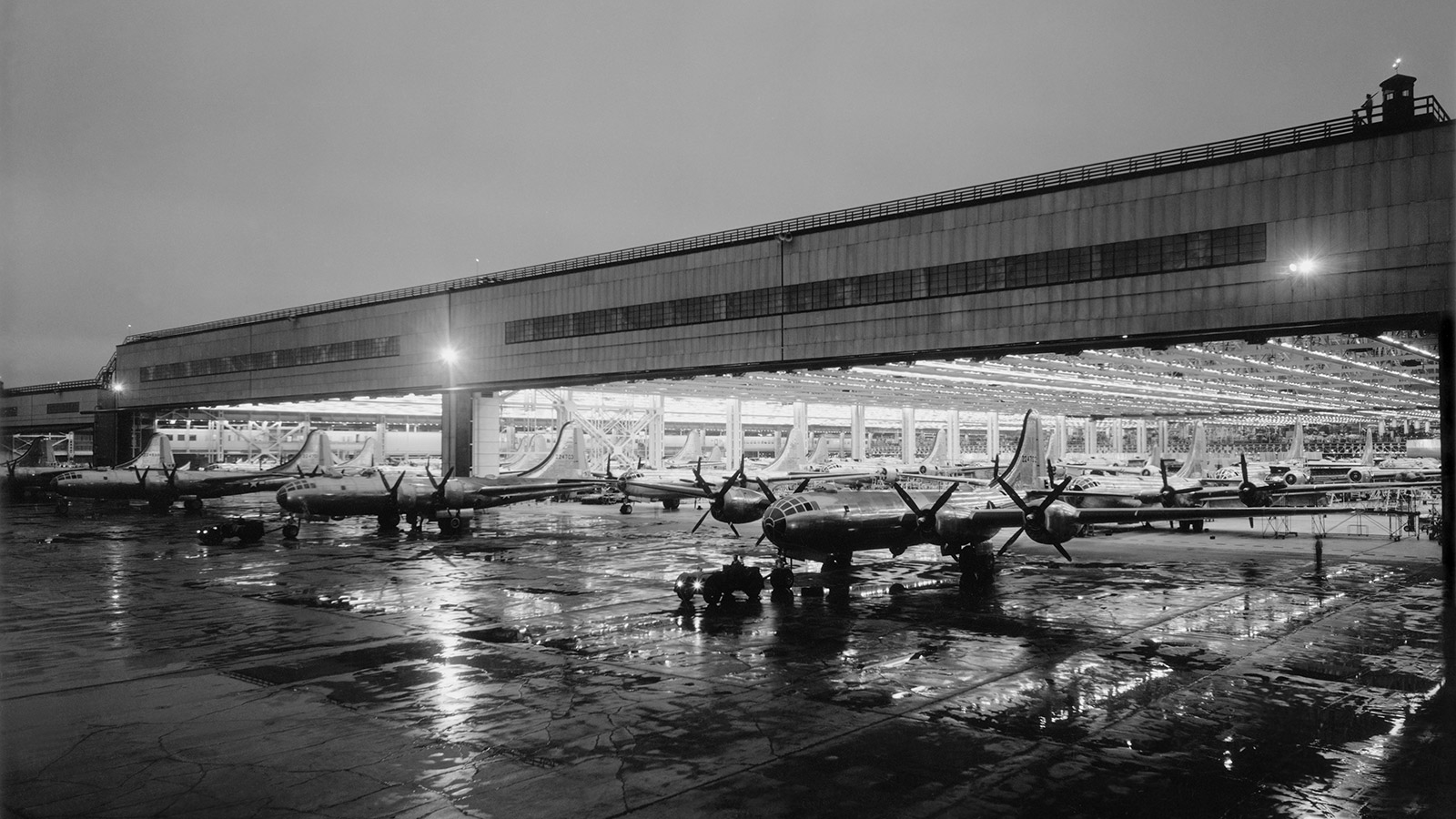 Black and white photo of fully built B-29 bombers coming out of the factory.