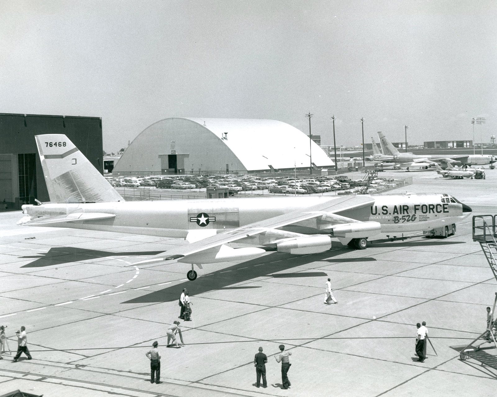 A black and white photo of a B-52 bomber sitting on the tarmac outside of the plant.