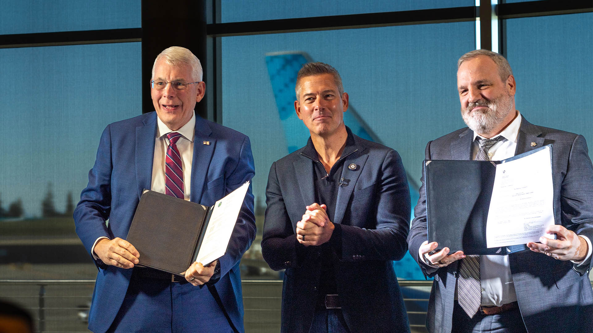 United States Department of Transportation Secretary Sean Duffy, center, presents the certification documents to Boeing 737 Development Program Chief Engineer Jim Williams, left, and Vice President & Program Manager of 737 Development Programs Chris Payne, right. 