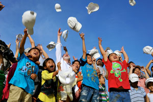 People tossing hats in the air.