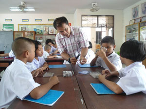 Group of young students with a teacher opening a notebook