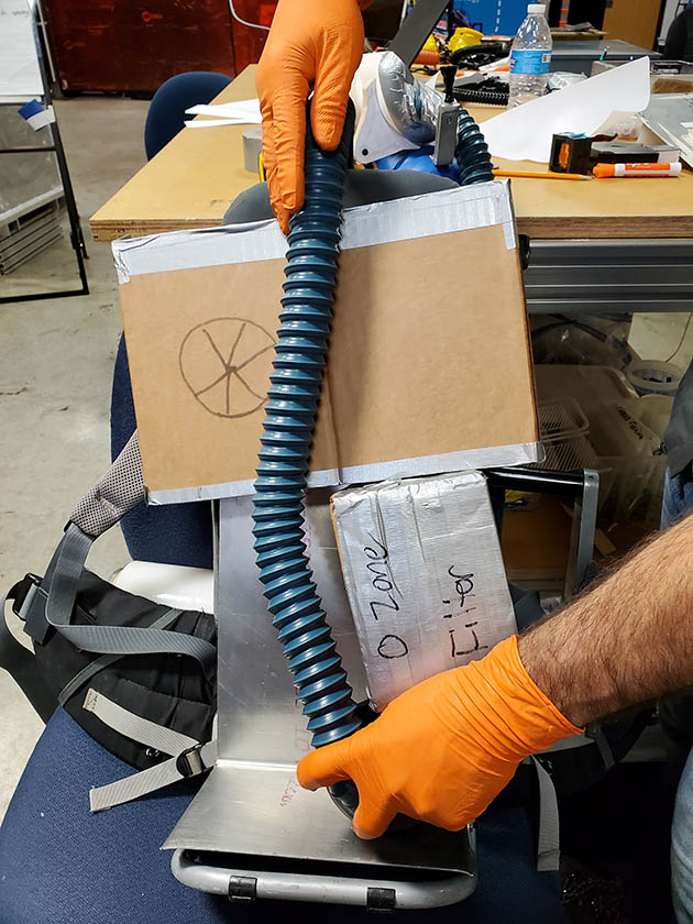 Model of the UV wand made of cardboard, a vacuum hose and duct tape