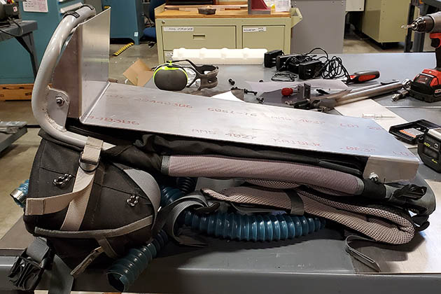 Repurposed baby backpack that holds batteries and the power supply