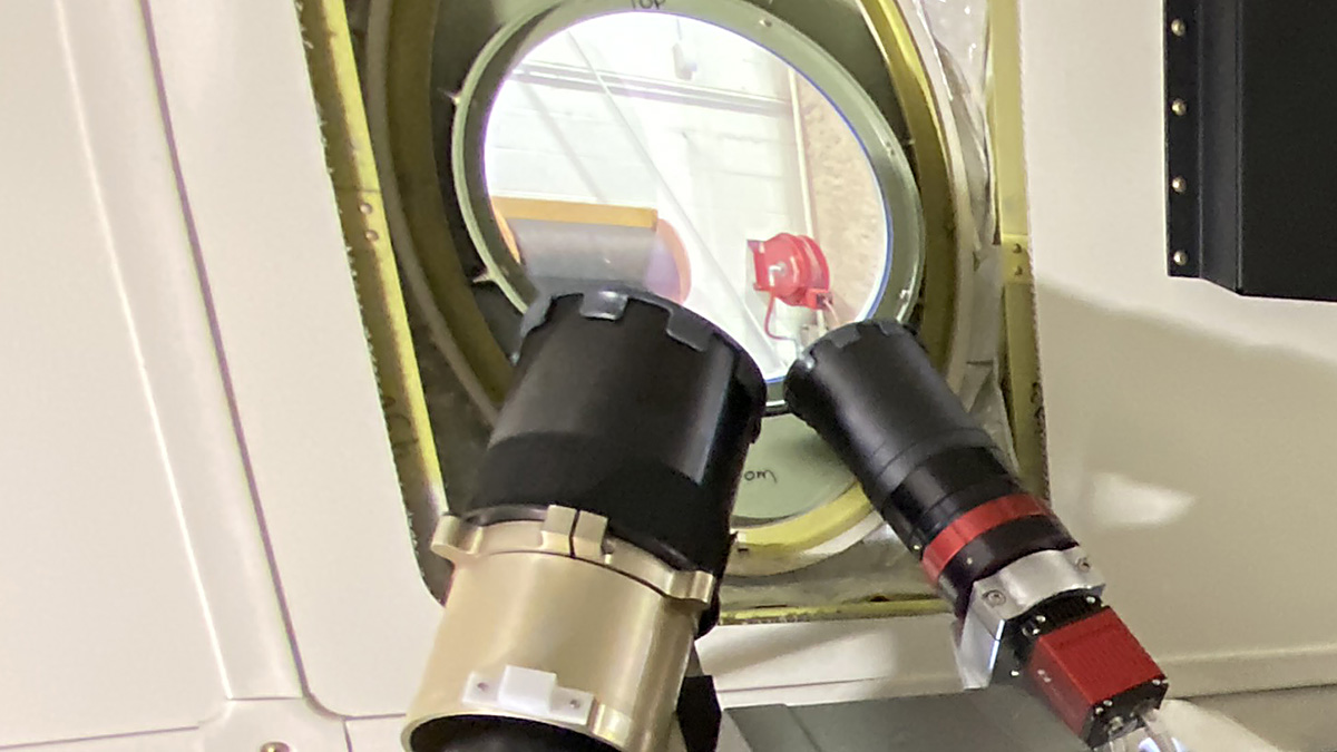 two small telescopes at airplane window