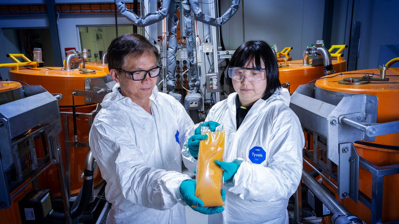 two engineers hold mixed resin package
