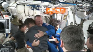 ISS Expedition 71 crew members welcome Starliner’s first crew, Butch Wilmore (center left) and Suni Williams (center right) on board the International Space Station.
