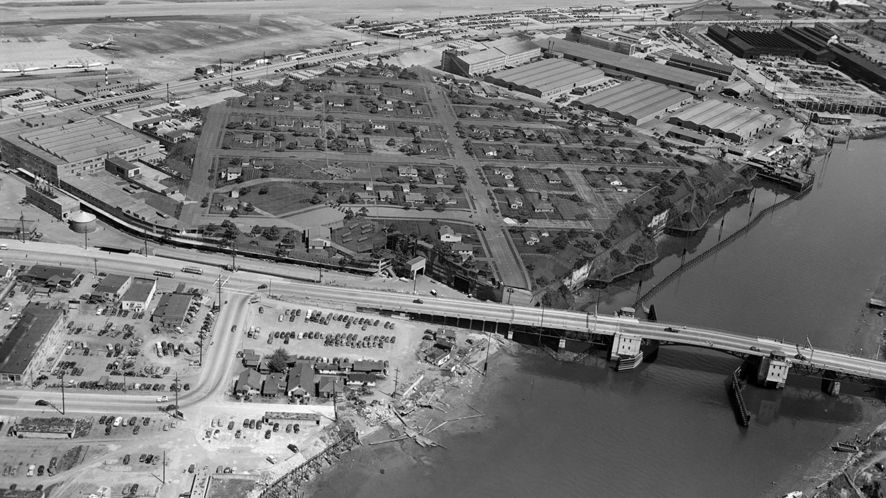 Historical image of overhead view of make-believe village constructed over Plant 2 to provide wartime cover.