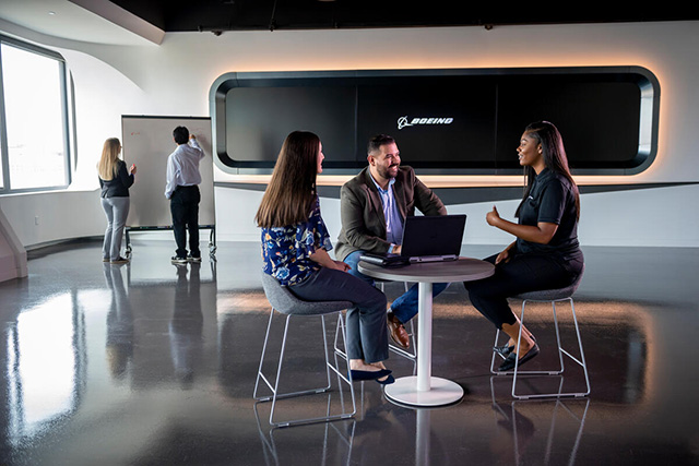 Picture of people sitting at a table having a discussion.