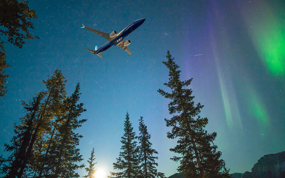 Image of the 7 3 7 dash 8 with Aurora Borealis in the background.