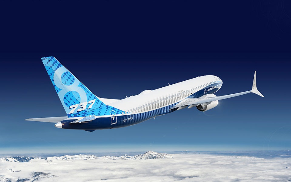 Image of the 7 3 7 dash 8 200 in flight, tail view.