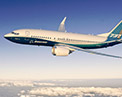 Image of the 7 3 7 MAX 7 in flight, wing tip engine side view.