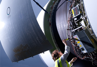 Picture of mechanic servicing airplane engine.