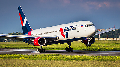 Picture of AZUR Air livery plane landing on runway.