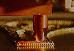 Close up picture of a 3 D component being built.