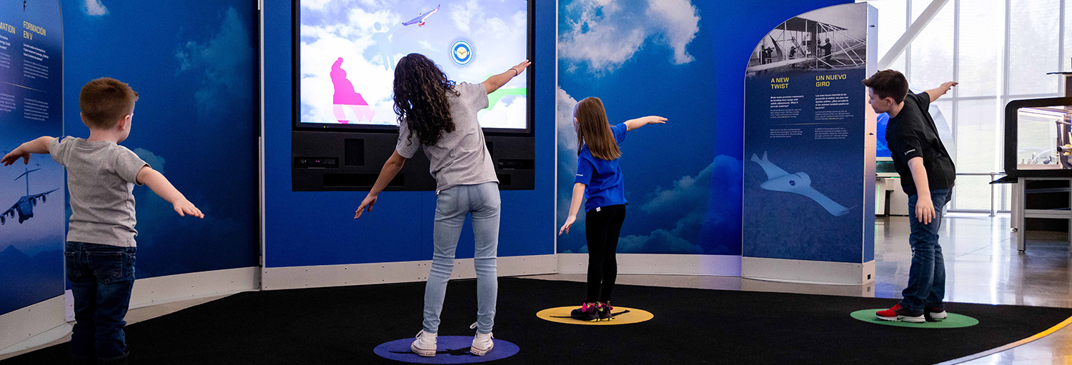 Kids learning about aviation at the Above and Beyond Future of Flight exhibit.