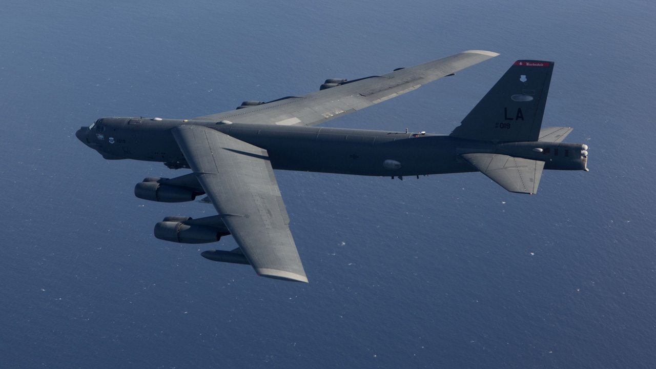 Picture of a B-52H aircraft in flight over water.