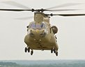 Picture of a CH-47 F Chinook hover over water.