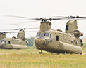 Two CH-47F Chinooks in a field.