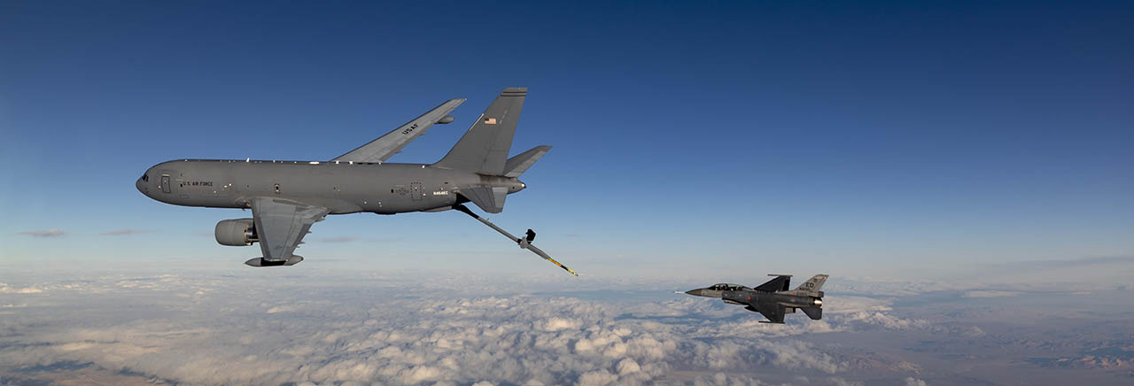 Side view of a KC-46A aerial refueling an F-16