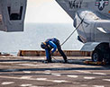 Picture of the V-22 Osprey and service personnel on flight deck.