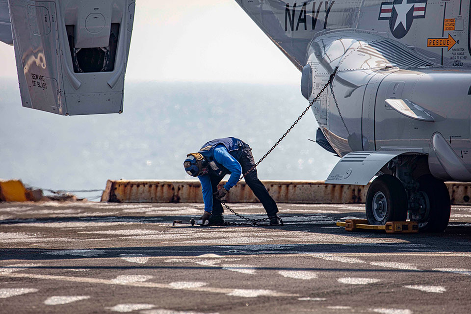 Picture of the V-22 Osprey and service personnel on flight deck.