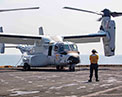 Picture of the V-22 Osprey and personnel on flight deck.