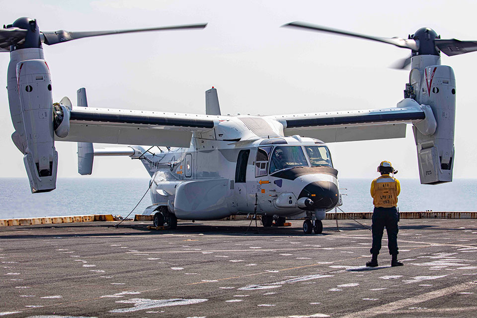 Picture of the V-22 Osprey and personnel on flight deck.