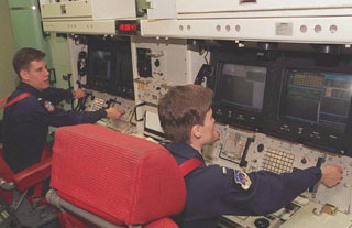 Personnel at controls 