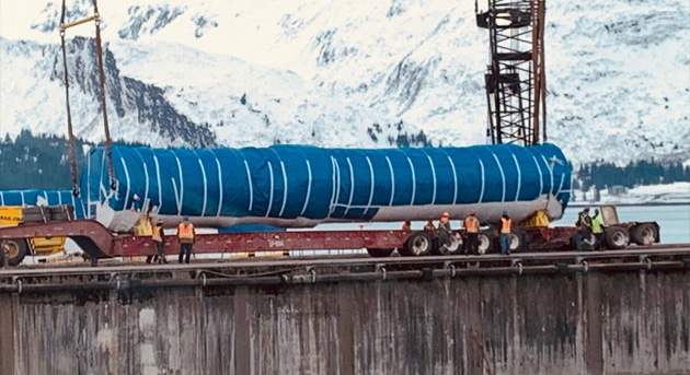 Silo and silo interface vaults are removed from the barge in Valdez, Alaska, and placed onto a truck for transport to Fort Greely, Alaska.