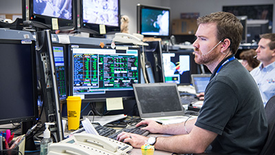 Boeing's James Dickson works at his console in the Mission Evaluation Room at Mission Control.