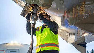 Aviation maintenance technician Frank Farstad loads sustainable aviation fuel into the 2021 Boeing ecoDemonstrator.