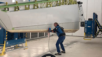 Exoskeleton used to sand 787 horizontal stabilizer