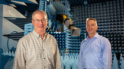 Boeing tech and engineer with antenna-measuring robot