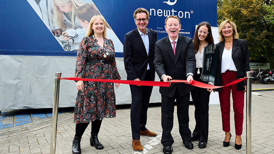 Belgian students using an aircraft simulator inside the Mobile Newton Room.
