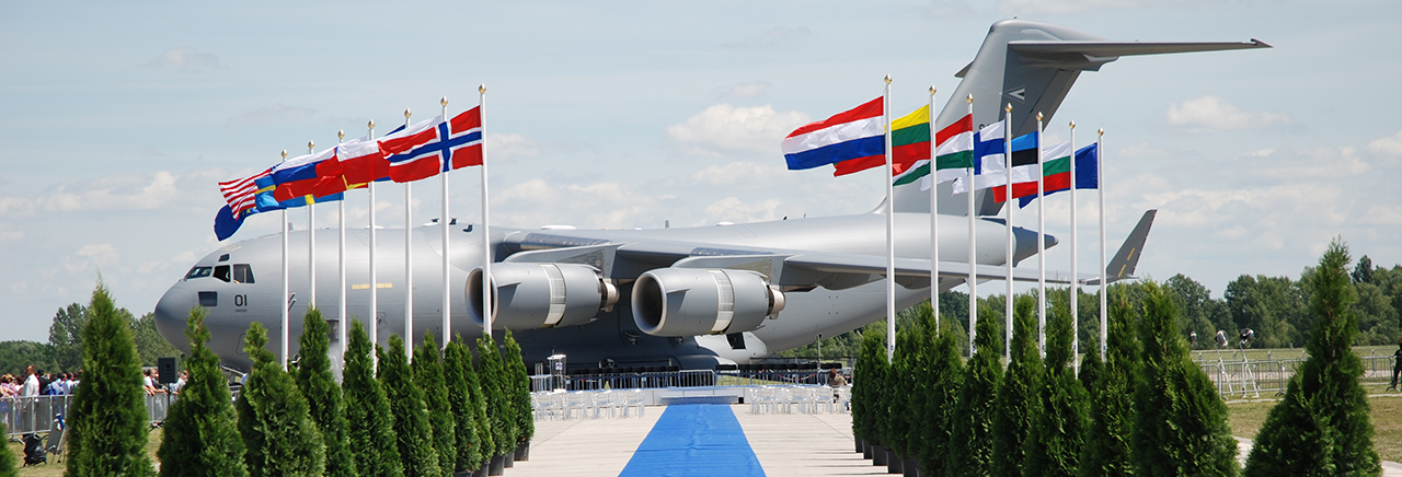 Boeing aircraft behind row of country flags. Text: BOEING SOLUTIONS FOR NATO & PARTNERS IN EUROPE