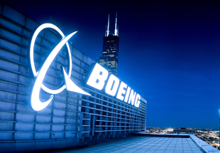 Picture of the Boeing corporate office building at night.